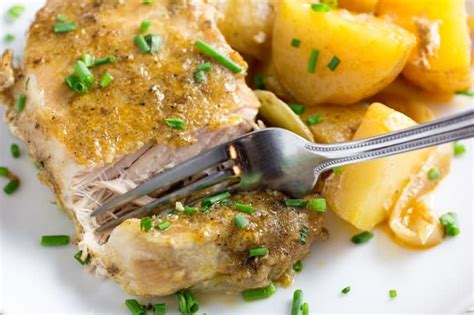 slow-cooker-pork-chops-potatoes-dishing-delish image