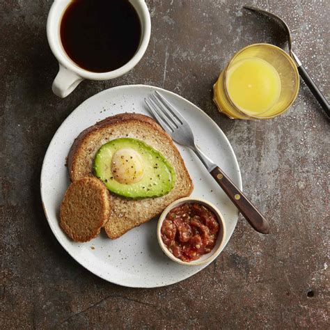 avocado-egg-in-a-hole-toasts-recipe-eatingwell image
