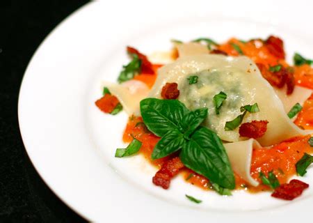 goat-cheese-arugula-ravioli-with-tomato-pancetta-butter image
