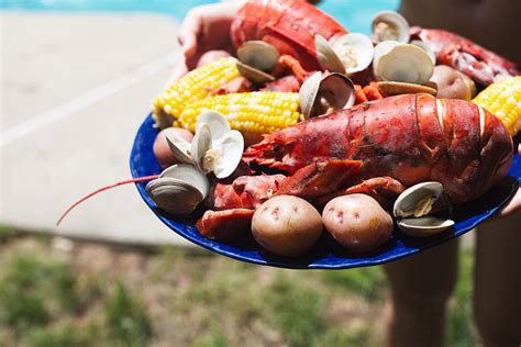 classic-new-england-lobster-boil-cooking-with-cocktail image