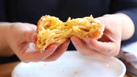 bite-into-deep-fried-spaghetti-balls-at-bar-cargo-in image