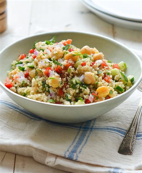 bulgur-salad-with-cucumbers-red-peppers-chick-peas-lemon image
