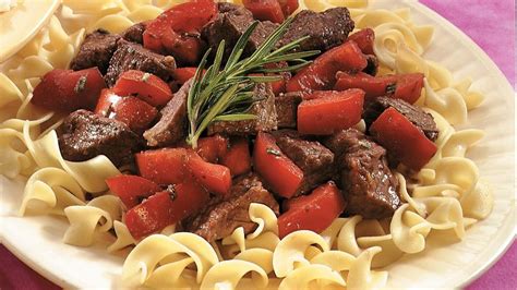 slow-cooked-rosemary-beef-and-tomatoes-over-noodles image