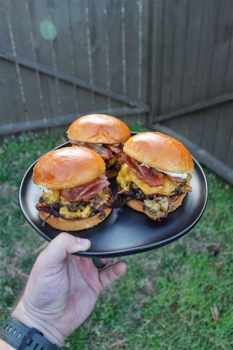 cheesy-onion-smash-burgers-over-the-fire-cooking image