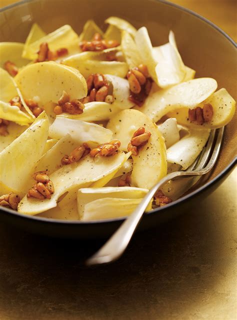 endive-and-apple-salad-with-honey-caramelized-pine-nuts image
