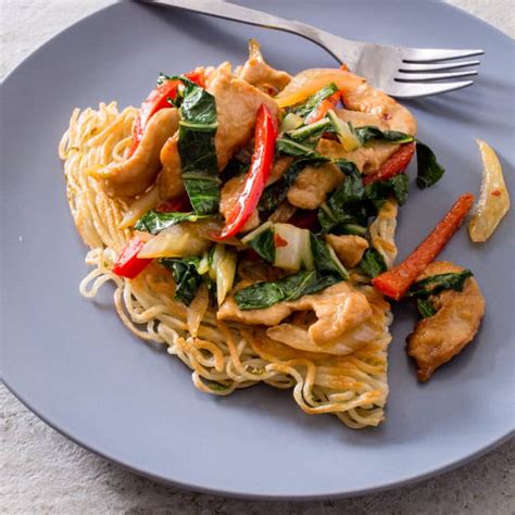 stir-fried-chicken-with-bok-choy-and-crispy-noodle-cake image