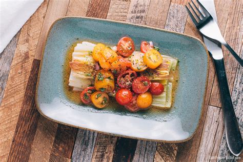 braised-leeks-with-tomato-vinaigrette-salt-pepper image
