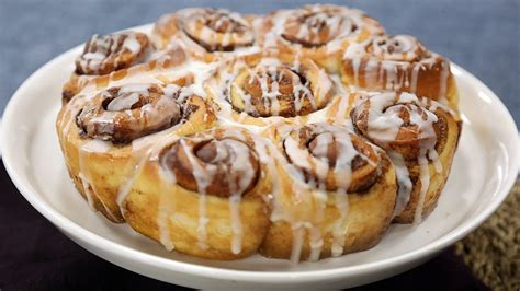 sticky-cinnamon-buns-with-icing-sugar-golden-syrup-milk image