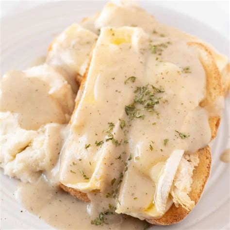 open-faced-turkey-sandwich-with-gravy-a-table-full-of image