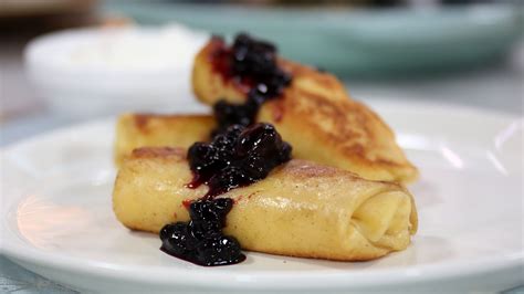 cottage-cheese-blintzes-with-blueberry-sauce-sour-cream image