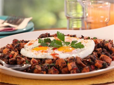 jerk-pork-belly-and-sweet-potato-hash-with-fried-eggs image