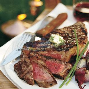 grilled-rib-eye-steaks-with-parsley-garlic-butter-epicurious image