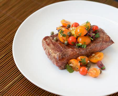 seared-rib-eye-steak-with-tomato-caper-relish-love image