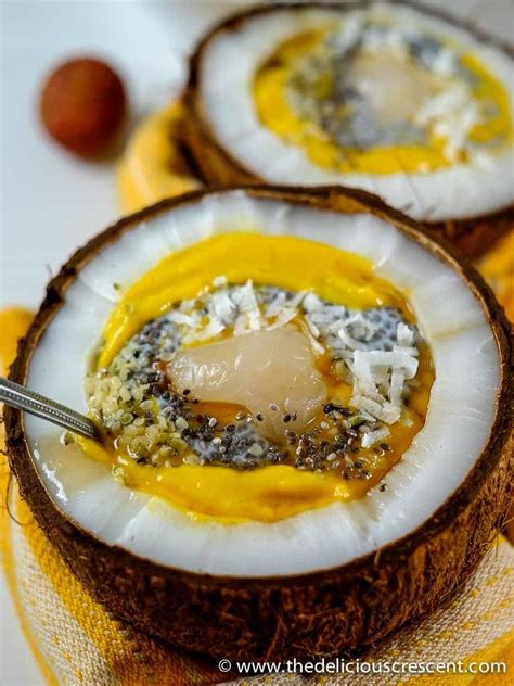 coconut-mango-smoothie-bowl-the-delicious-crescent image