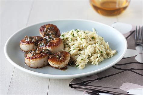 seared-scallops-with-herb-butter-sauce-and-orzo image