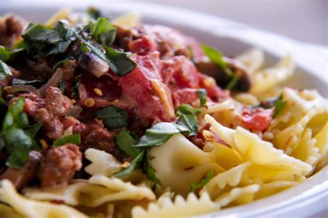 bowtie-pasta-with-sausage-tomatoes-and-cream-a image