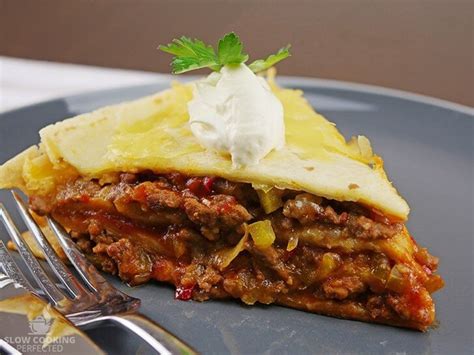 layered-slow-cooker-beef-enchiladas-slow-cooking image