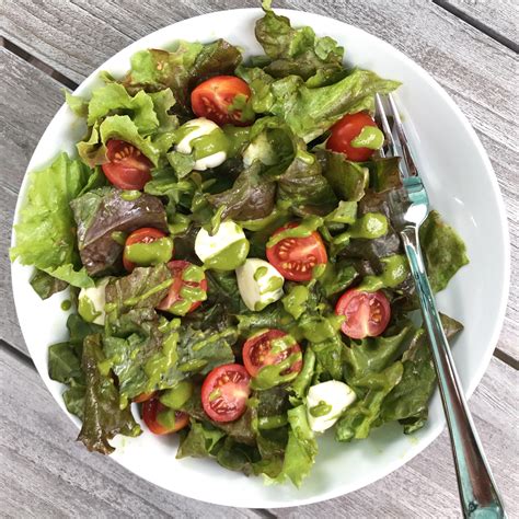 caprese-salad-with-greens-and-basil-vinaigrette image
