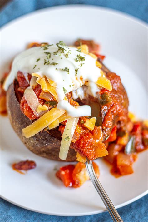baked-potatoes-with-chili-cheese-and-sour-cream image
