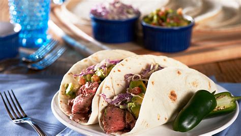steak-tacos-with-chipotle-slaw-avocado-salsa image