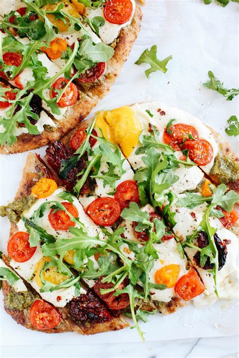 garlicky-pesto-flatbread-pizza-with-tomatoes-arugula image