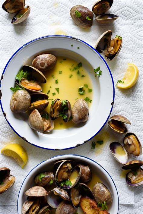 grilled-manila-clams-with-lemon-herb-butter-fork image