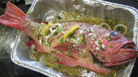 roast-red-snapper-w-fresh-herbs-garlic-and-olive-oil image
