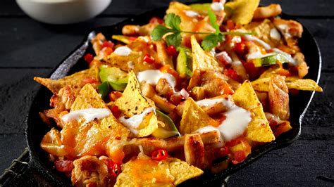 taco-nachos-with-diced-tomatoes-and-shredded-cheese image