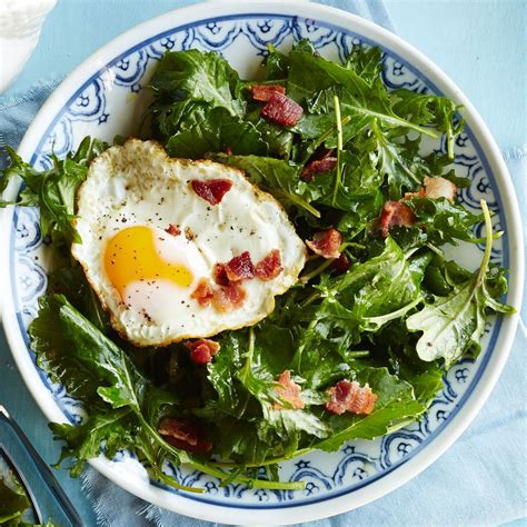 baby-kale-breakfast-salad-with-bacon-egg-eatingwell image