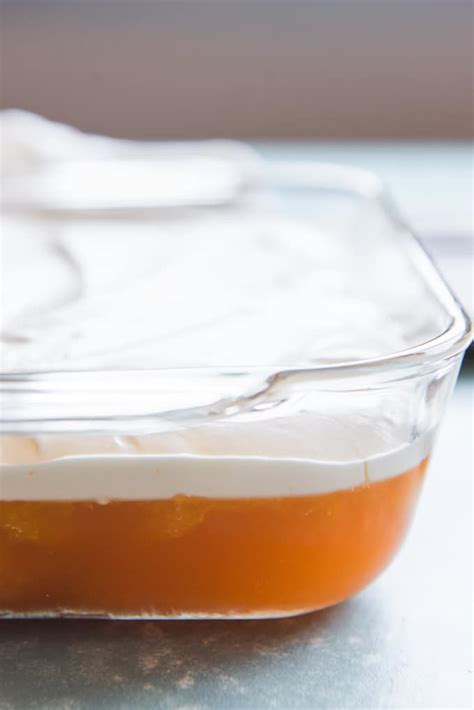 orange-jello-salad-with-pudding-whipped-cream image