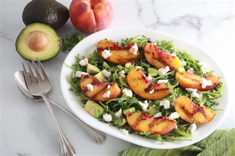 grilled-peach-avocado-and-goat-cheese-arugula-salad image