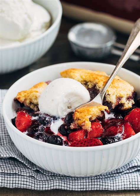 mixed-berry-cobbler-with-cornmeal-biscuit-topping image