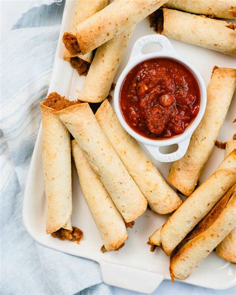 easy-baked-flautas-taquitos-a-couple-cooks image