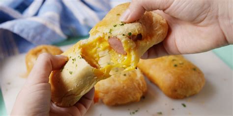 best-cheesy-hot-dogs-in-a-blanket-recipe-delish image