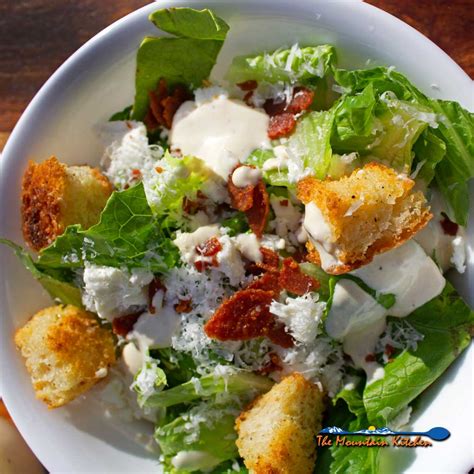 caesar-salad-with-pepperoni-bits-and-feta-the image