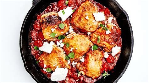 chicken-thighs-with-burst-tomatoes-harissa-and-feta image
