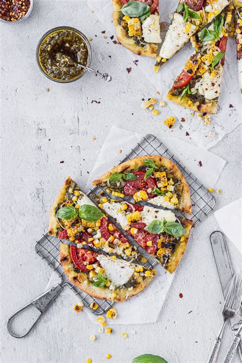 flatbread-pizza-with-pesto-burrata-and-corn-fork-in-the image
