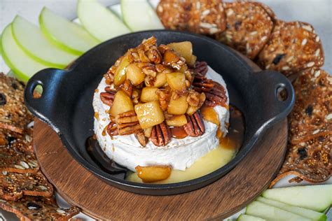 baked-brie-with-apples-and-pecans-couple-in-the image