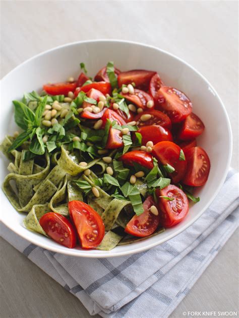 spinach-pasta-with-tomatoes-pine-nuts-and-basil image