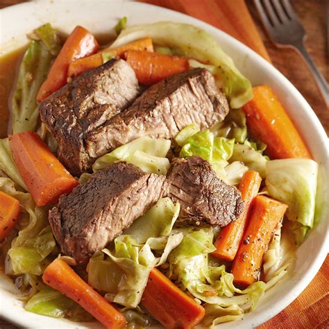 slow-cooked-beef-with-carrots-cabbage-eatingwell image