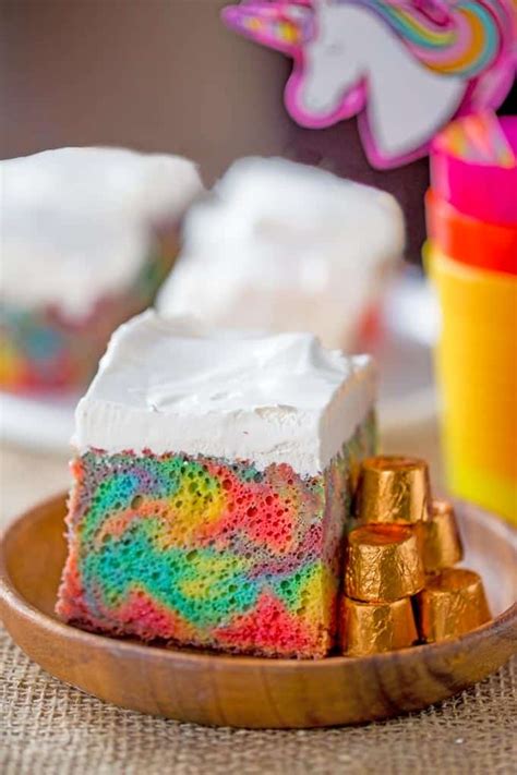 rainbow-poke-cake-with-whipped-cream-dinner image