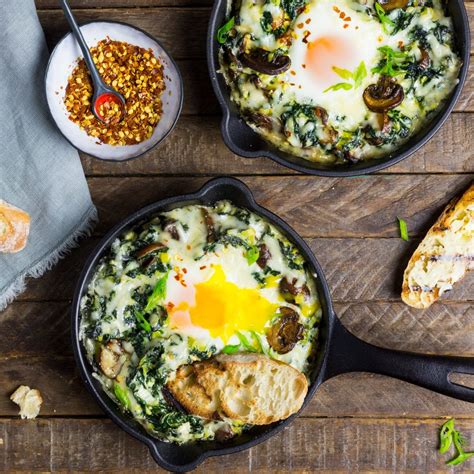 baked-eggs-with-creamy-greens-and-garlic-butter-toasts image