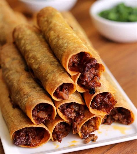 beef-and-cheese-baked-taquitos-kinda-healthy image