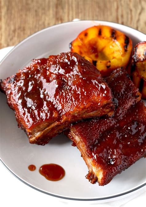 baked-pork-ribs-with-bourbon-peach-bbq-sauce image