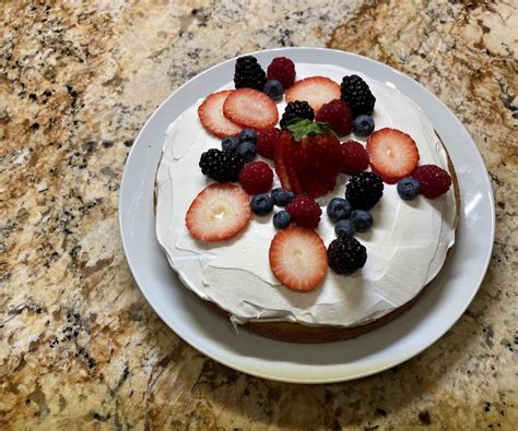 vanilla-and-lemon-pudding-cake-with-fresh-berries image