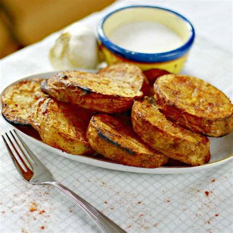 marinated-and-sliced-grilled-potatoes-dishing-delish image