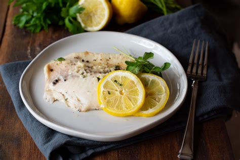 lemon-herb-baked-tilapia-with-two-spoons image