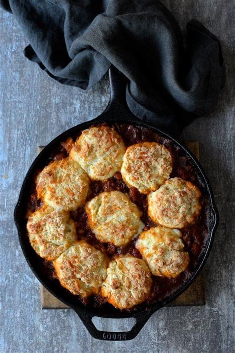 skillet-turkey-pinto-bean-chili-recipe-with-cheese-biscuit image