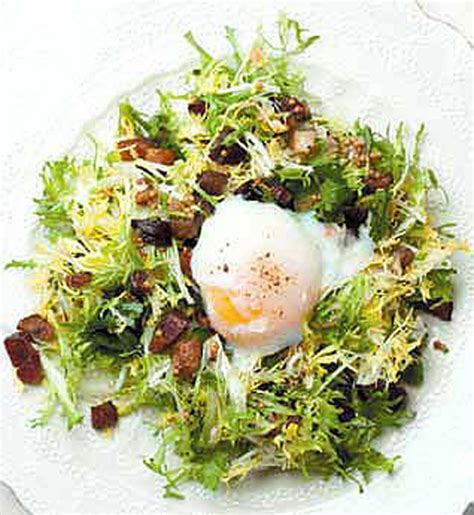 frisee-salad-with-lardons-and-a-poached-egg-edible image