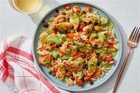 creamy-pesto-chicken-orzo-with-capers-currants image